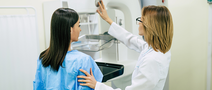 A clinician performs a mammogram on a patient after they conducted their own self breast examination in order to detect early breast cancer.