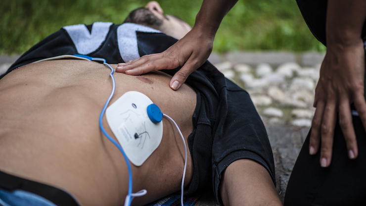 man being saved by a defibrillator
