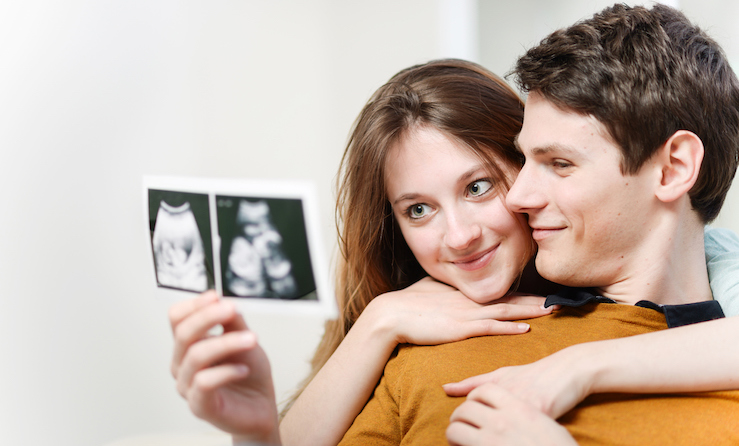 expectant parents looking at an ultrasound of their baby